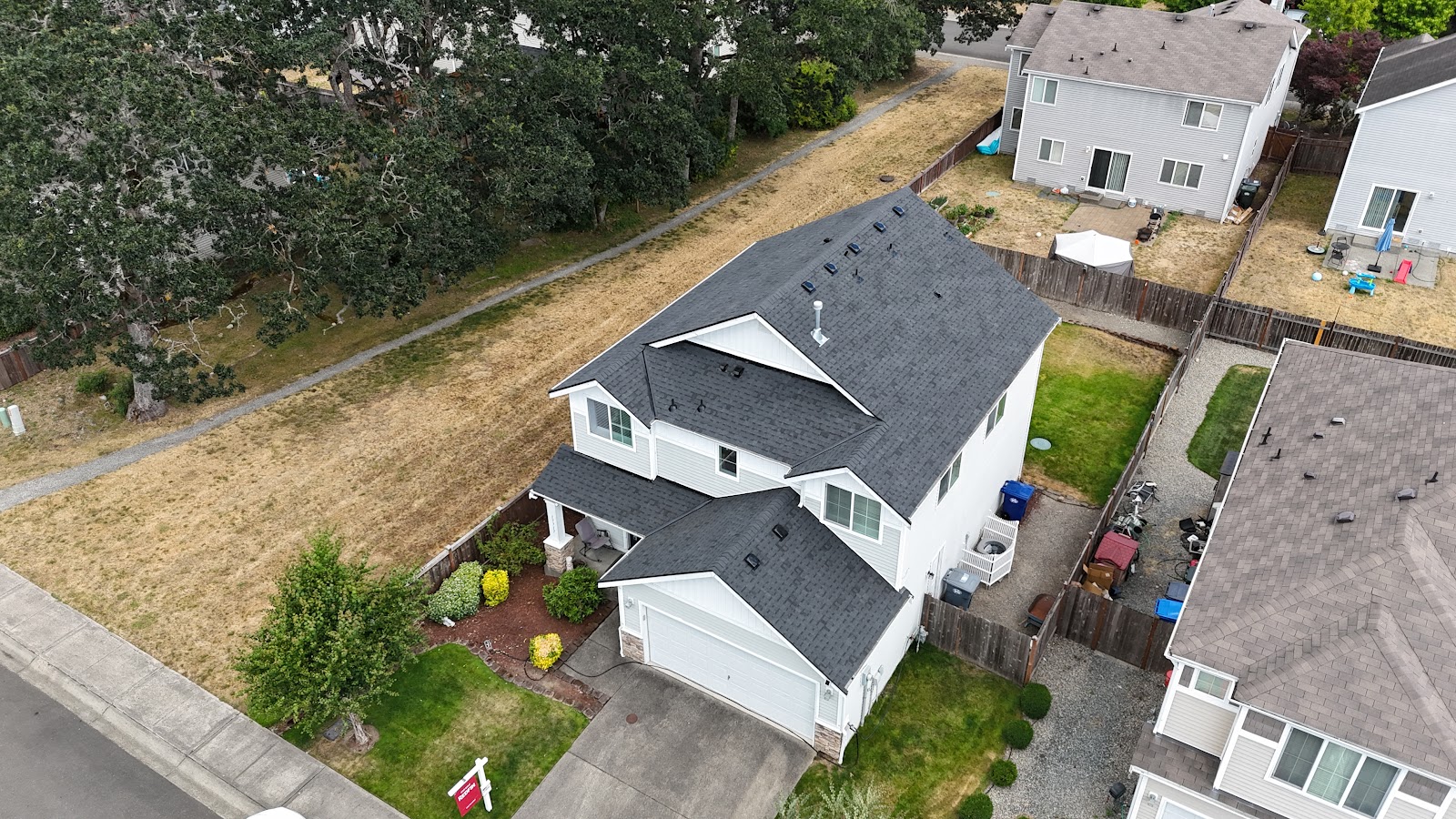Aerial view of a completed charcoal architectural-shingle roof replacement